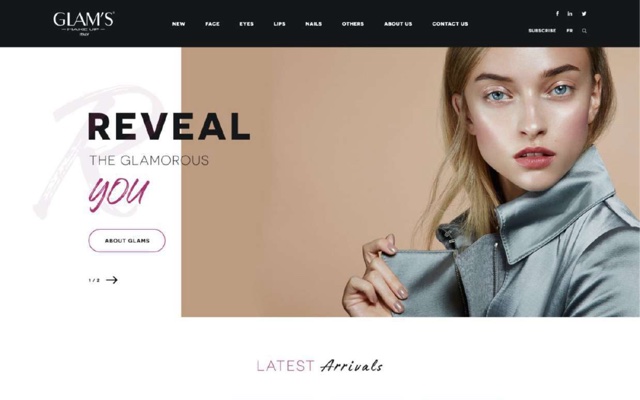 A landing page for Glam's, an Italian makeup brand. A model in a silver jacket against a tan background, with Reveal the glamorous you set in mixed capitals and script over a pale monogram.