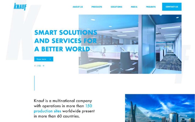 A blue and white landing page for Knauf, a building materials manufacturer. A photograph of an office interior beside the headline Smart solutions and services for a better world, with a pale oversized K behind it.
