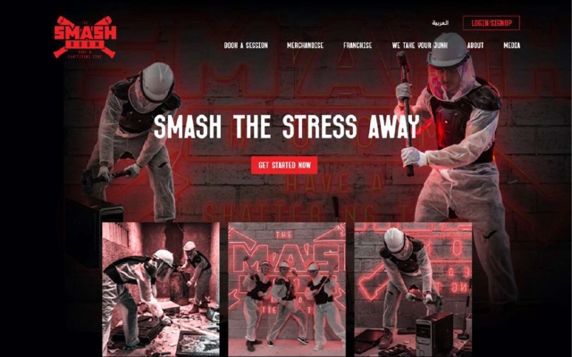 A dark red landing page for The Smash Room, a rage room in Dubai. A wall of neon and concrete behind two people in protective suits swinging a sledgehammer and a bat, with the headline Smash the stress away.